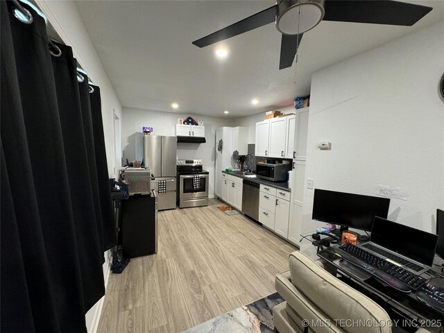233 W Madison Ave, Mcalester, OK 74501 - kitchen featuring appliances with stainless steel finishes, white cabinetry, dark countertops, light wood-type flooring, and ceiling fan