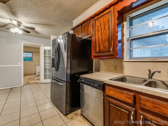 12641 S 281st E Ave, Coweta, OK 74429 - kitchen featuring stainless steel appliances, a sink, light tile patterned flooring, a ceiling fan, and a textured ceiling