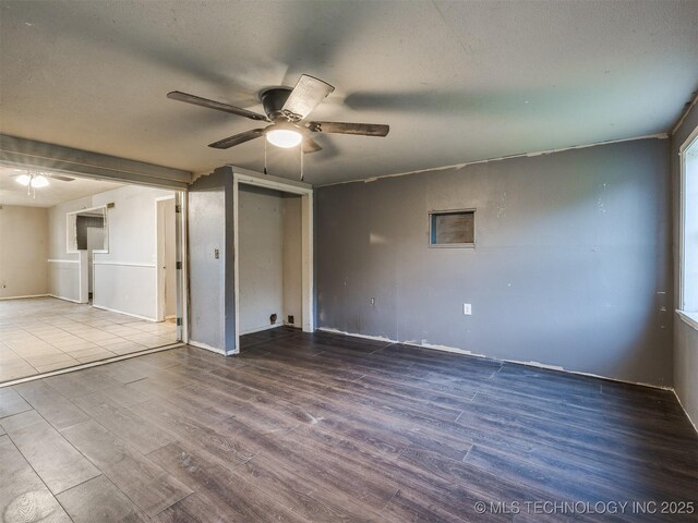 12641 S 281st E Ave, Coweta, OK 74429 - spare room with ceiling fan, wood finished floors, a textured ceiling, and baseboards