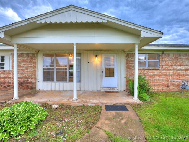 12641 S 281st E Ave, Coweta, OK 74429 - property entrance with brick siding, covered porch, and board and batten siding