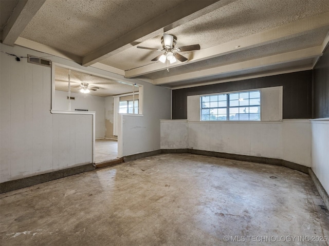 12641 S 281st E Ave, Coweta, OK 74429 - below grade area featuring ceiling fan, a textured ceiling, baseboards, and wood walls