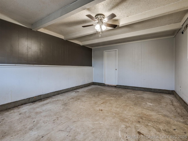 12641 S 281st E Ave, Coweta, OK 74429 - spare room featuring beamed ceiling, unfinished concrete floors, wooden walls, ceiling fan, and a textured ceiling