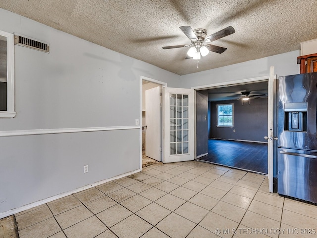 12641 S 281st E Ave, Coweta, OK 74429 - empty room featuring a ceiling fan, light tile patterned floors, and a textured ceiling