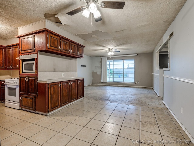 12641 S 281st E Ave, Coweta, OK 74429 - kitchen featuring ceiling fan, white appliances, a textured ceiling, light countertops, and light tile patterned floors