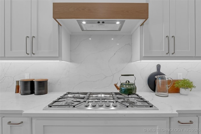 1227 N 71st Pl, Broken Arrow, OK 74014 - kitchen with stainless steel gas stovetop, white cabinets, and decorative backsplash