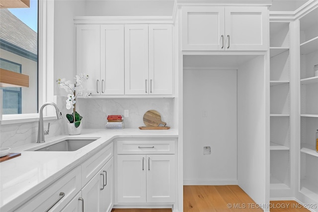 1227 N 71st Pl, Broken Arrow, OK 74014 - kitchen featuring a sink, white cabinets, and backsplash