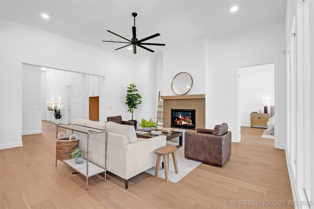 1227 N 71st Pl, Broken Arrow, OK 74014 - living area featuring ceiling fan, crown molding, a glass covered fireplace, light wood-style floors, and recessed lighting