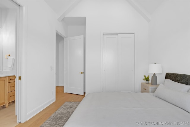 1227 N 71st Pl, Broken Arrow, OK 74014 - bedroom with light wood-style flooring, vaulted ceiling, a closet, baseboards, and connected bathroom