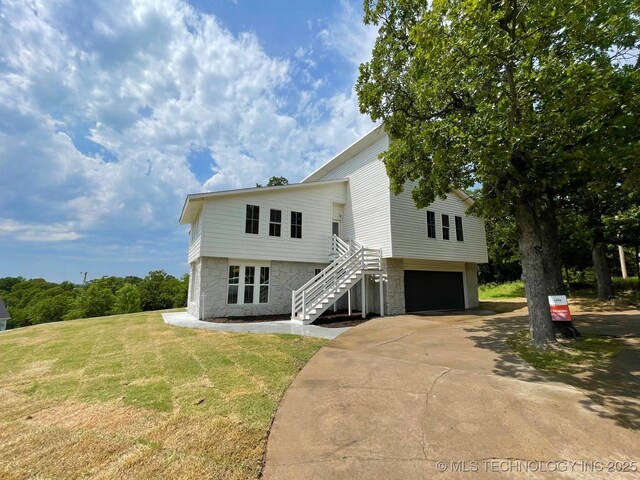 228 W Hickory Dr, Sand Springs, OK 74063 - view of front of property with stone siding, stairway, a garage, a front yard, and driveway