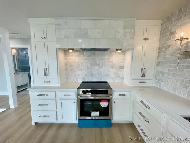 228 W Hickory Dr, Sand Springs, OK 74063 - kitchen with stainless steel range with electric stovetop, decorative backsplash, and light countertops