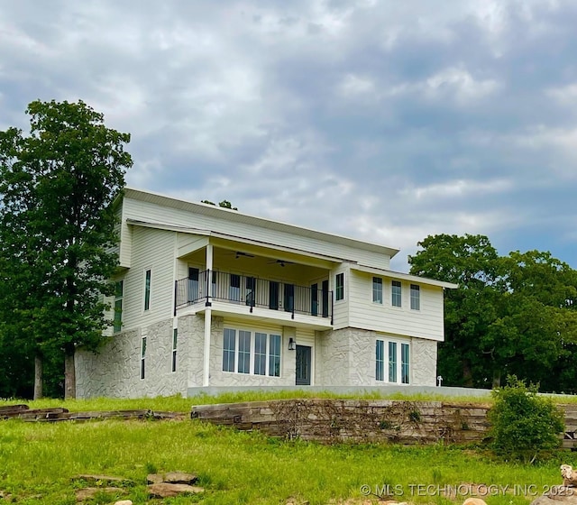 228 W Hickory Dr, Sand Springs, OK 74063 - rear view of property featuring a balcony, ceiling fan, and stone siding