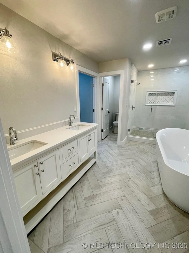 228 W Hickory Dr, Sand Springs, OK 74063 - full bathroom featuring a shower stall, a freestanding tub, toilet, and double vanity