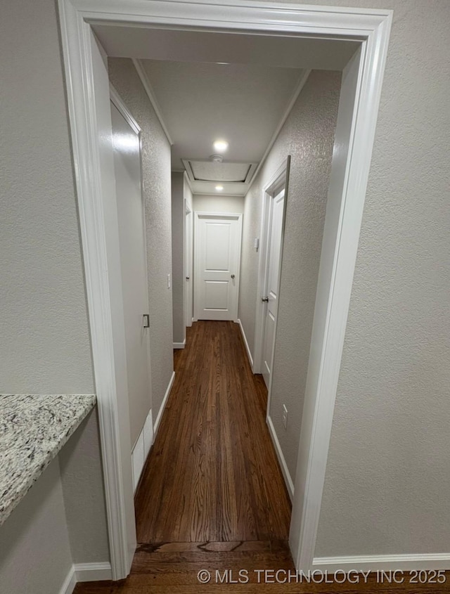 6837 E King Pl, Tulsa, OK 74115 - hall with dark wood-type flooring, a textured wall, and baseboards