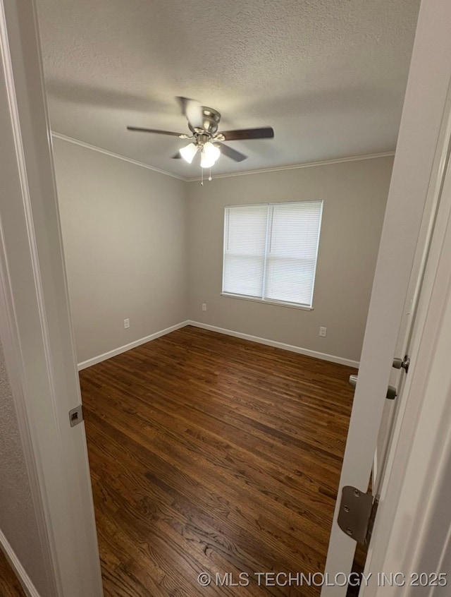 6837 E King Pl, Tulsa, OK 74115 - unfurnished room featuring crown molding, baseboards, ceiling fan, a textured ceiling, and dark wood-type flooring