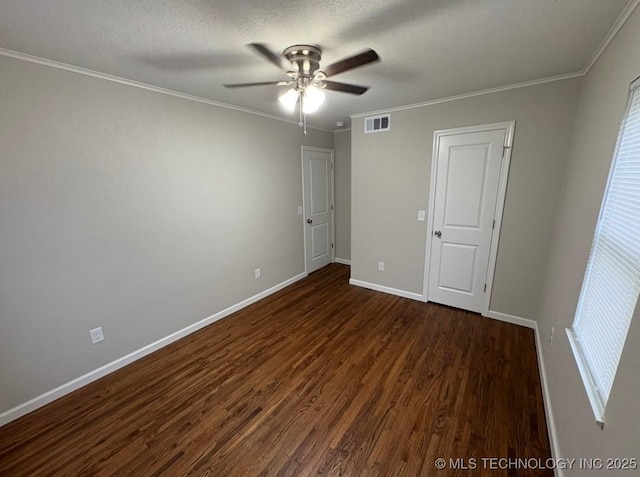 6837 E King Pl, Tulsa, OK 74115 - unfurnished bedroom featuring dark wood-style flooring, baseboards, ornamental molding, a textured ceiling, and ceiling fan
