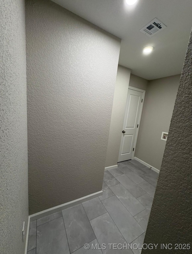 6837 E King Pl, Tulsa, OK 74115 - hallway with baseboards and a textured wall
