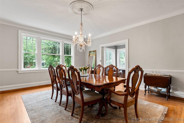 319 E 21st St, Tulsa, OK 74114 - dining space featuring ornamental molding, plenty of natural light, a chandelier, and wood finished floors