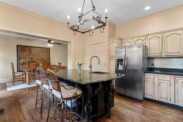 319 E 21st St, Tulsa, OK 74114 - kitchen featuring stainless steel fridge with ice dispenser, a sink, ornamental molding, a chandelier, and dark stone countertops