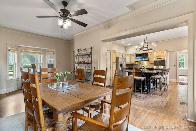 319 E 21st St, Tulsa, OK 74114 - dining area with ornamental molding, light wood-style flooring, healthy amount of natural light, and baseboards
