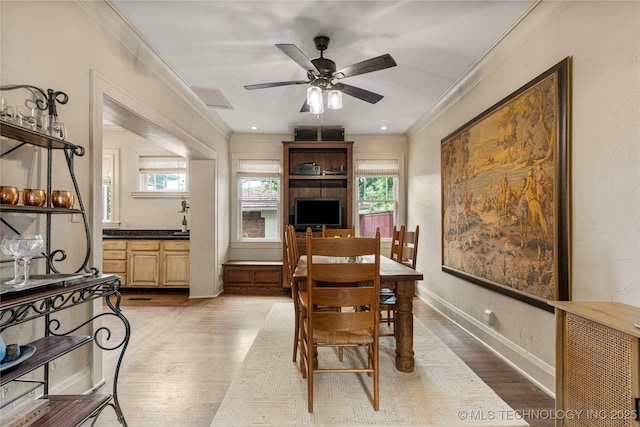 319 E 21st St, Tulsa, OK 74114 - dining space with light wood-style floors, a ceiling fan, crown molding, and baseboards