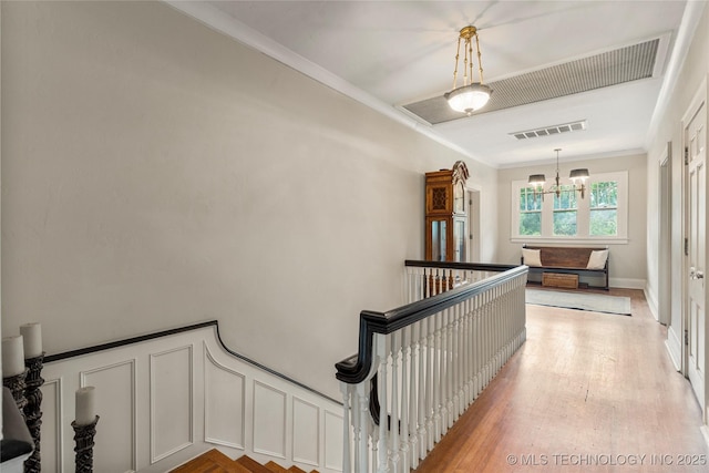 319 E 21st St, Tulsa, OK 74114 - stairway with a chandelier, ornamental molding, and wood finished floors