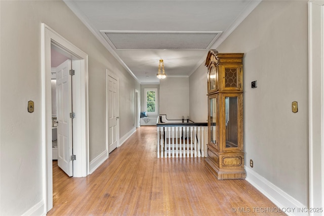 319 E 21st St, Tulsa, OK 74114 - hallway with light wood finished floors, crown molding, and baseboards