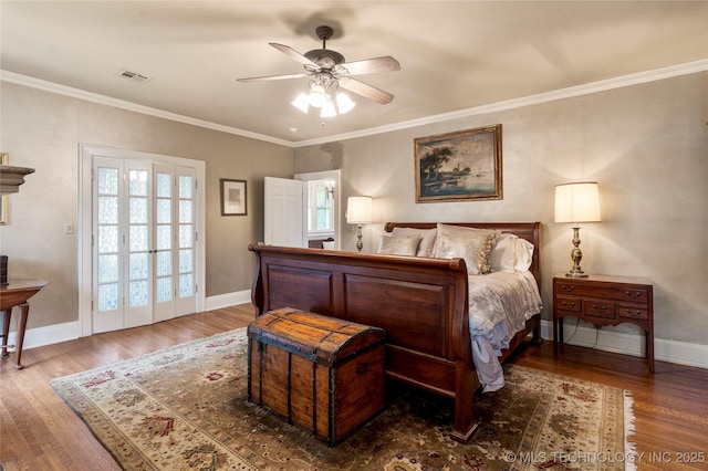 319 E 21st St, Tulsa, OK 74114 - bedroom with wood finished floors, baseboards, and ornamental molding