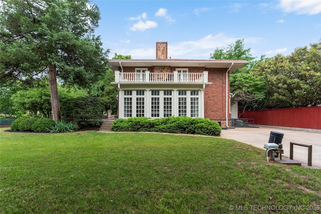 319 E 21st St, Tulsa, OK 74114 - back of house with a balcony, a chimney, brick siding, and a patio