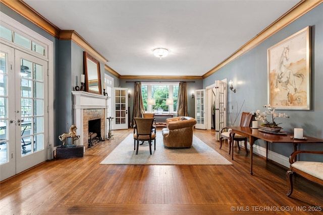 319 E 21st St, Tulsa, OK 74114 - living area featuring crown molding, french doors, wood finished floors, and a fireplace