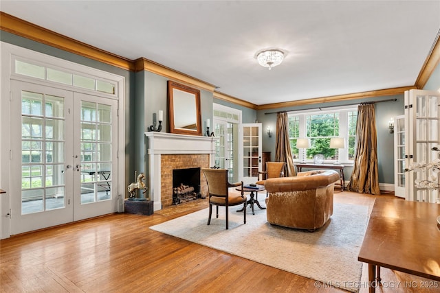 319 E 21st St, Tulsa, OK 74114 - living area featuring french doors, ornamental molding, a fireplace, and wood finished floors