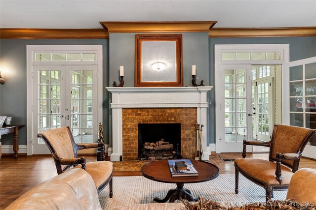 319 E 21st St, Tulsa, OK 74114 - living area featuring crown molding, french doors, wood finished floors, a fireplace, and baseboards