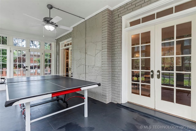 319 E 21st St, Tulsa, OK 74114 - game room featuring french doors, ceiling fan, dark tile patterned flooring, and crown molding