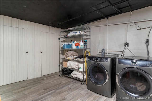 319 E 21st St, Tulsa, OK 74114 - washroom with washing machine and dryer and wood finished floors