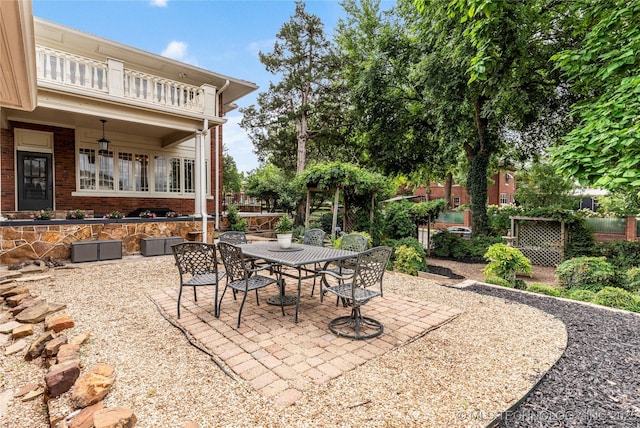 319 E 21st St, Tulsa, OK 74114 - view of patio featuring outdoor dining space and a balcony