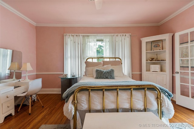 319 E 21st St, Tulsa, OK 74114 - bedroom with crown molding, wood finished floors, and baseboards