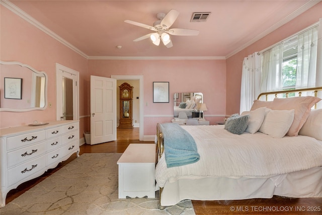 319 E 21st St, Tulsa, OK 74114 - bedroom with ornamental molding, wood finished floors, baseboards, and ceiling fan