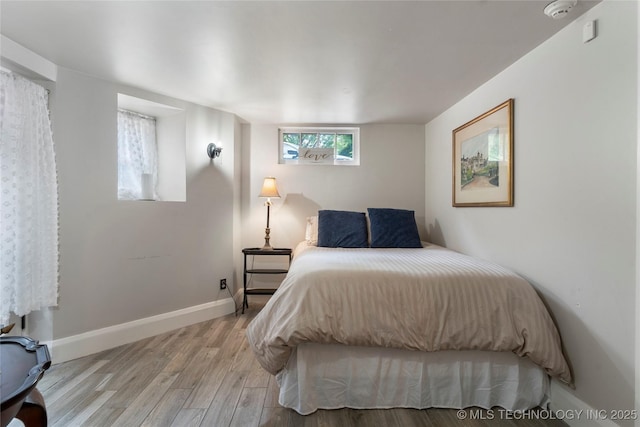 319 E 21st St, Tulsa, OK 74114 - bedroom featuring light wood-style floors and baseboards