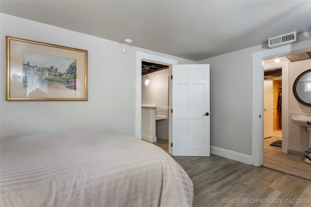 319 E 21st St, Tulsa, OK 74114 - bedroom with wood finished floors and baseboards