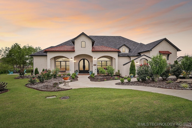 30907 E 68th St S, Broken Arrow, OK 74014 - view of front facade featuring stucco siding, a lawn, and french doors