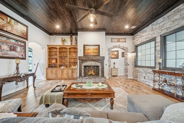 30907 E 68th St S, Broken Arrow, OK 74014 - living area with arched walkways, wooden ceiling, hardwood / wood-style floors, crown molding, and a stone fireplace