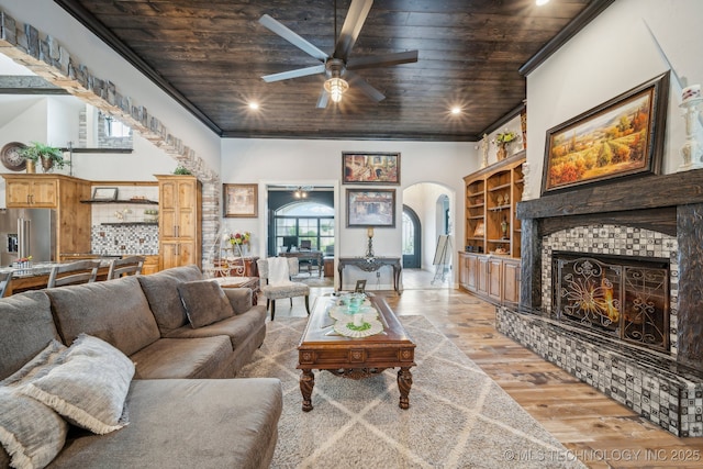 30907 E 68th St S, Broken Arrow, OK 74014 - living area with arched walkways, wooden ceiling, ceiling fan, light wood-style floors, and ornamental molding