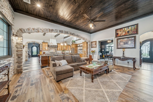 30907 E 68th St S, Broken Arrow, OK 74014 - living room featuring arched walkways, ceiling fan, wood ceiling, wood-type flooring, and ornamental molding
