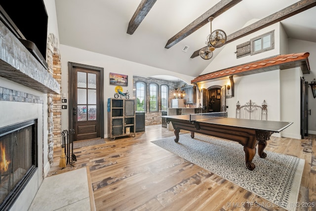 30907 E 68th St S, Broken Arrow, OK 74014 - playroom with arched walkways, a chandelier, beamed ceiling, a fireplace with flush hearth, and high vaulted ceiling