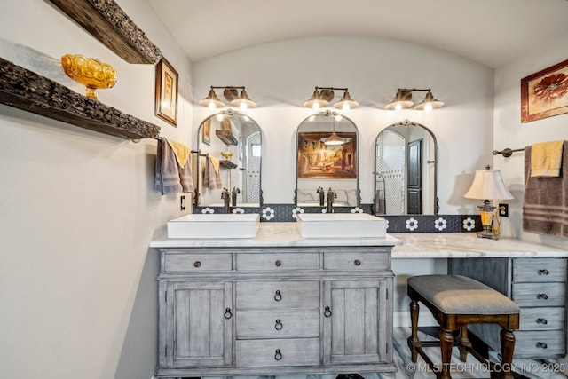30907 E 68th St S, Broken Arrow, OK 74014 - bathroom featuring double vanity and vaulted ceiling