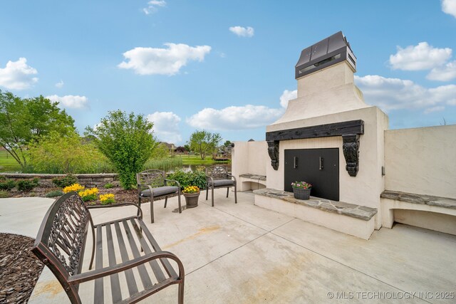 30907 E 68th St S, Broken Arrow, OK 74014 - view of patio featuring an outdoor fireplace