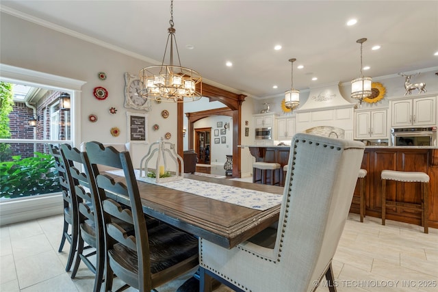11406 69th E Pl, Bixby, OK 74008 - dining room featuring recessed lighting, crown molding, a chandelier, arched walkways, and light tile patterned floors