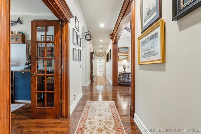11406 69th E Pl, Bixby, OK 74008 - corridor featuring wood finished floors, baseboards, recessed lighting, and arched walkways