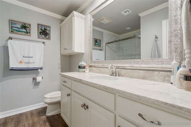 11406 69th E Pl, Bixby, OK 74008 - bathroom with vanity, toilet, a shower stall, ornamental molding, and wood finished floors
