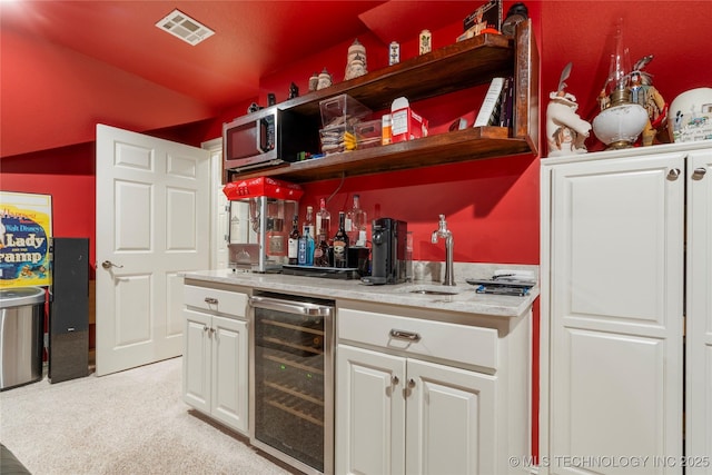 11406 69th E Pl, Bixby, OK 74008 - indoor wet bar with wine cooler, light colored carpet, stainless steel microwave, and vaulted ceiling