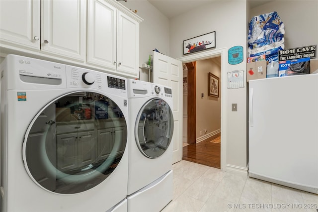 11406 69th E Pl, Bixby, OK 74008 - washroom featuring separate washer and dryer, cabinet space, light tile patterned floors, and baseboards